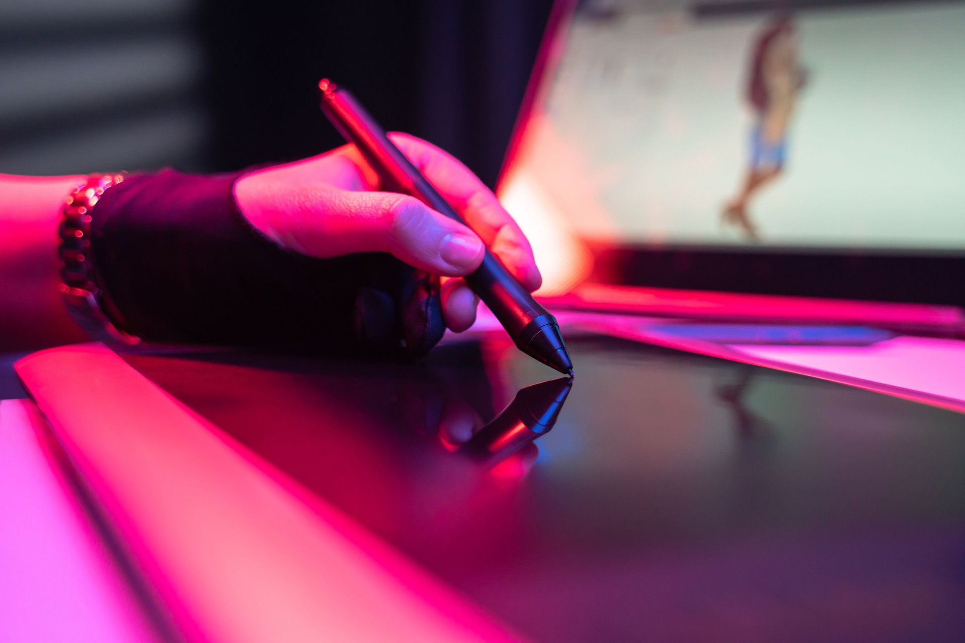 Girl's hand of illustrator graphic designer working drawing with laptop external keyboard tablet and digital pen